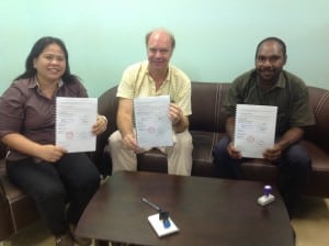 Femili PNG CEO and staff from the Department of Community Development after signing an MOU.