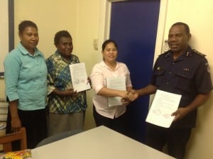 Constable Mairi Aiafon, Senior Constable Odilia Samoa, Femili PNG CEO and Senior Social Worker Daisy Plana and Provincial Police Commander-in-Chief Superintendent Kaiglo Ambane after signing the MOU.