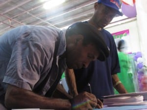A male show goer signing up to pledge his support to stop any form of violence against women.