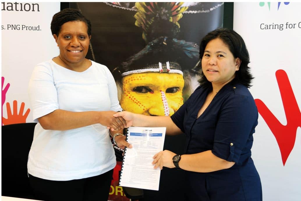 Oil Search Foundation, CEO, Kymberley Kepore (L) and Daisy Plana (R), CEO of Femili PNG solidify the agreement with a handshake that will see improved access to response services, health providers and referral for survivors of GBV in Hela.