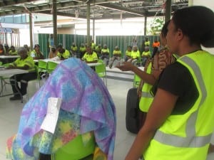 Laga Industries workers watch a skit showing how case management helps survivors of abuse.